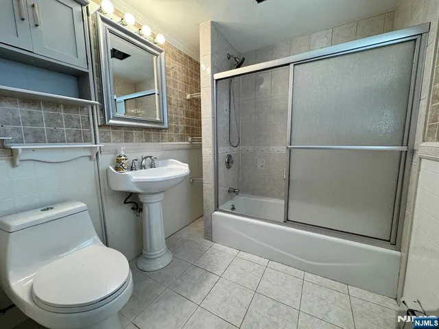 a bathroom with a toilet a sink and shower