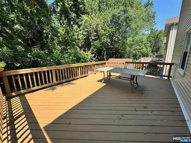 a view of balcony with wooden floor and outdoor seating