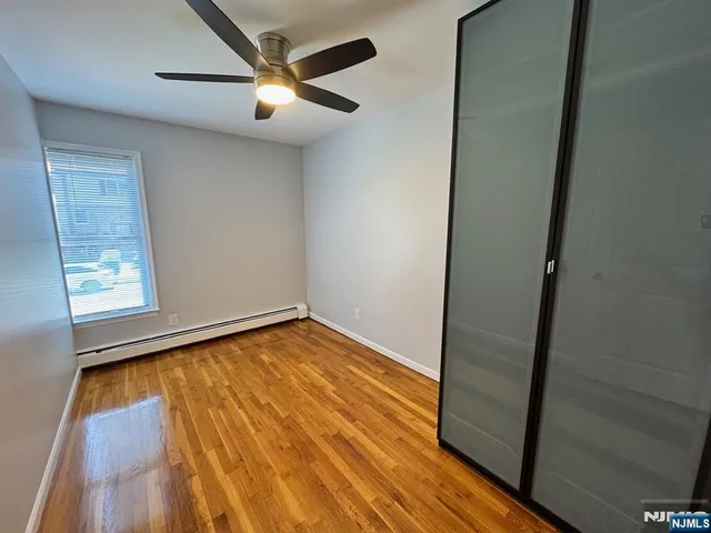 a car parked in front of a house with a garden