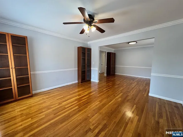 a view of an empty room and wooden floor
