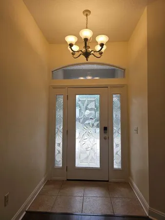 a view of an entryway with a chandelier