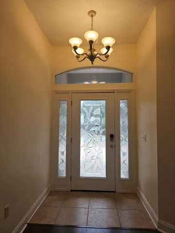 a view of an entryway with a chandelier