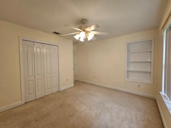 a view of an empty room with a fan