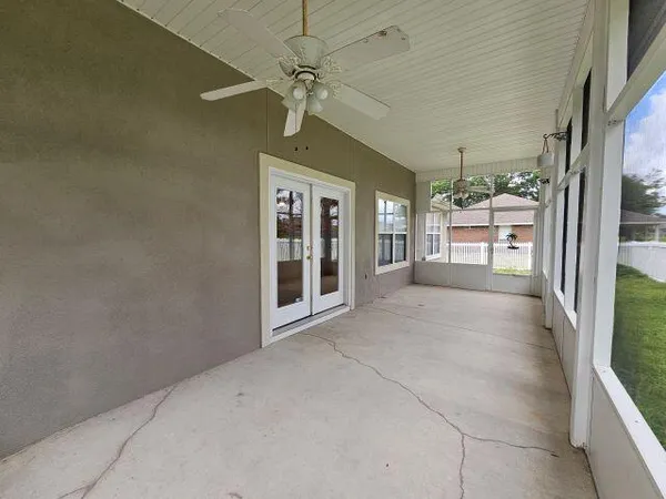 a view of a room with wooden floor and windows