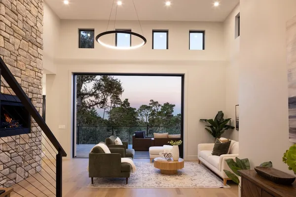 a living room with furniture and a floor to ceiling window
