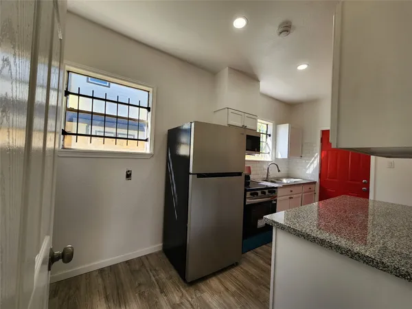 a kitchen with a refrigerator and a sink