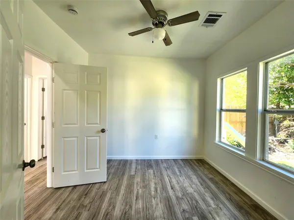 wooden floor in an empty room with a window