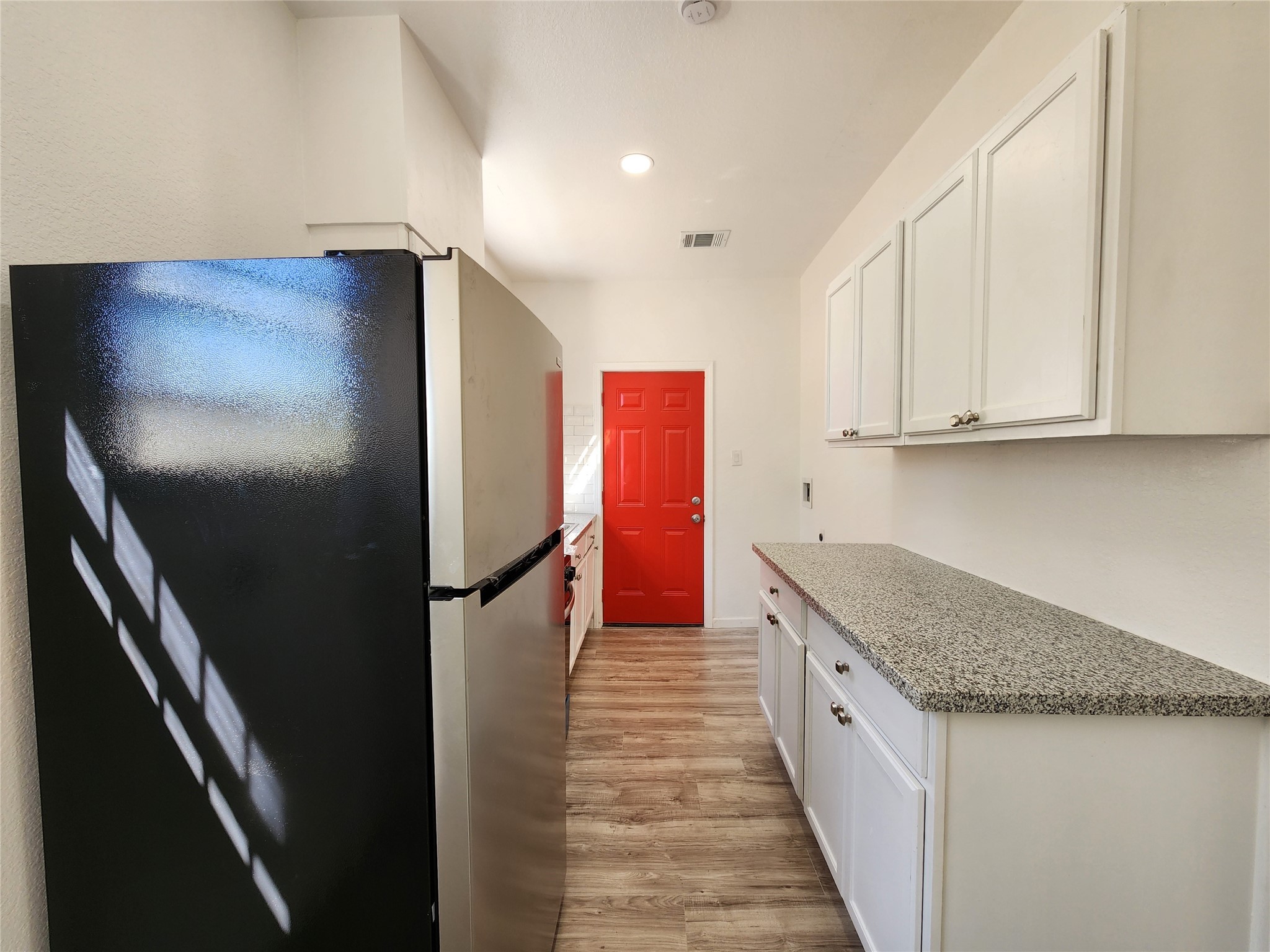 2706 1/2 Berry Street Houston, TX 77004 - Photo 6 of 14 a kitchen with stainless steel appliances granite countertop a refrigerator and a sink