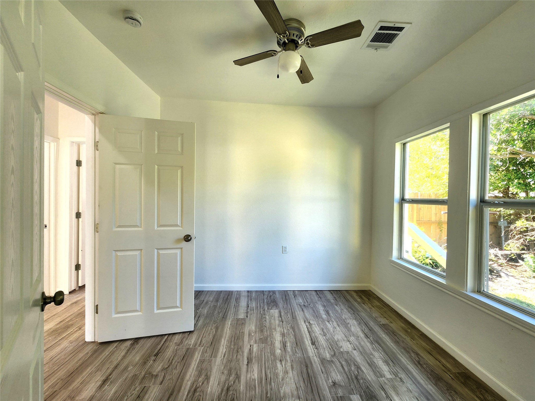 2706 1/2 Berry Street Houston, TX 77004 - Photo 7 of 14 wooden floor in an empty room with a window