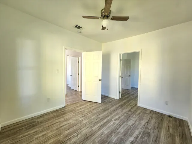 a view of an empty room and wooden floor