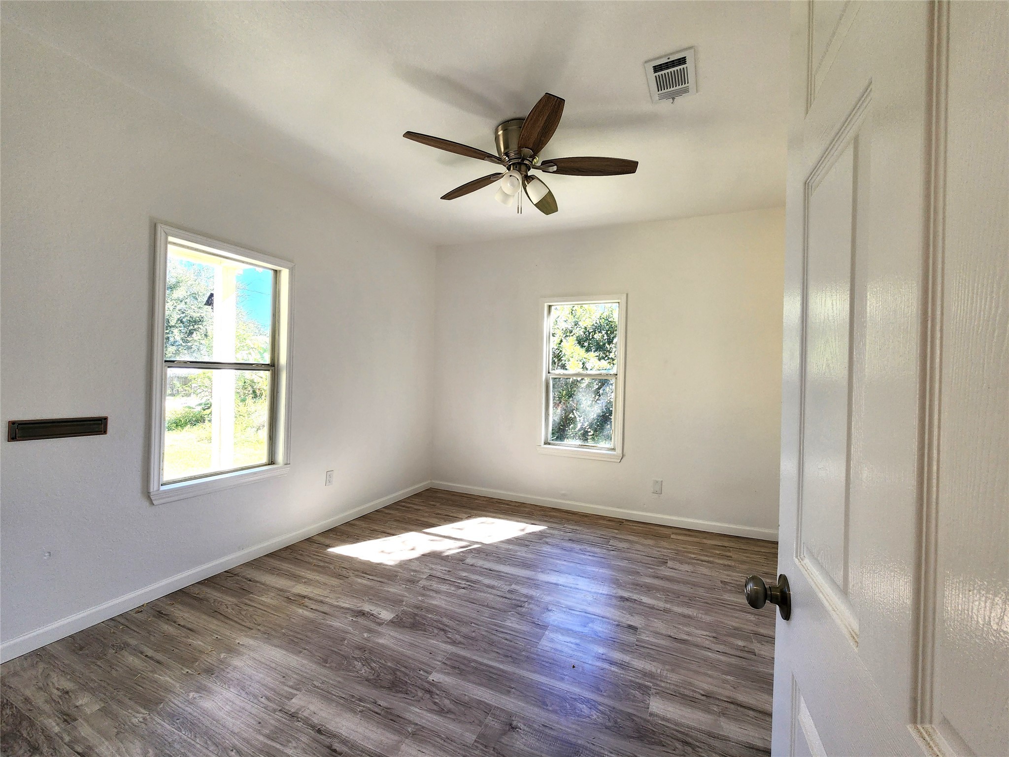 2706 1/2 Berry Street Houston, TX 77004 - Photo 9 of 14 a view of empty room with wooden floor and fan