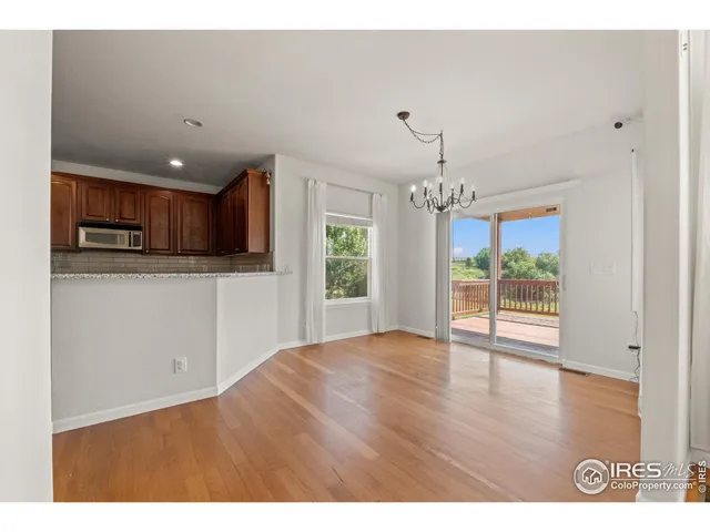 a view of a kitchen with a sink and a large window