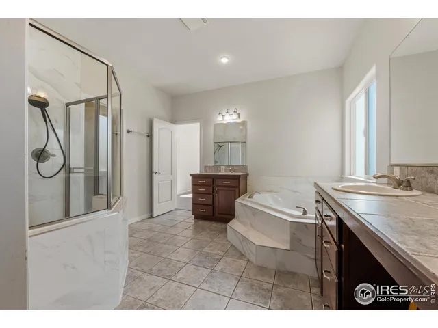 a bathroom with a granite countertop sink a toilet and a mirror