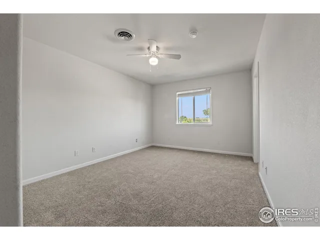 a bathroom with a granite countertop sink a toilet and a mirror