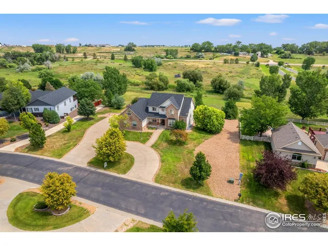 an aerial view of residential houses with outdoor space and river
