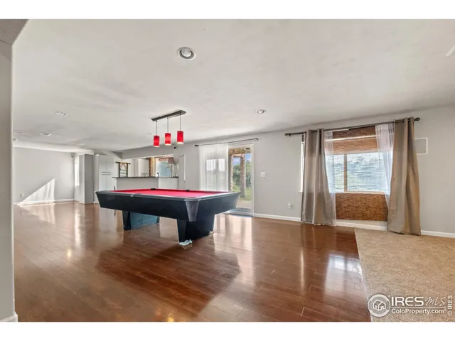 a open kitchen with a sink and wooden floor