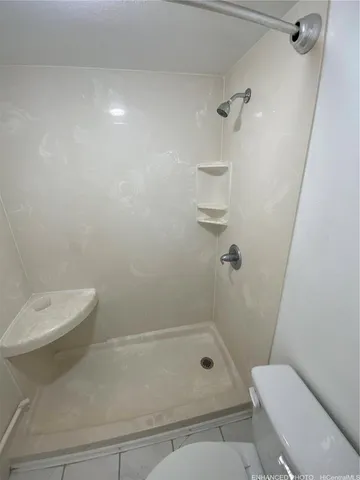 a bathroom with a toilet and shower