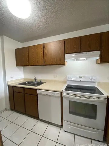 a kitchen with granite countertop cabinets and steel stainless steel appliances
