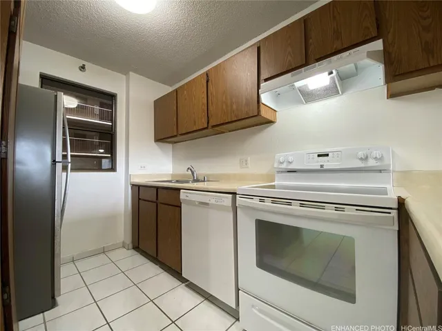 a kitchen with cabinets and steel stainless steel appliances