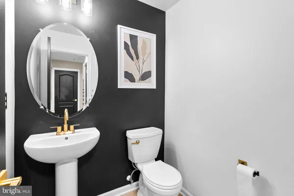 a bathroom with a toilet a sink and mirror