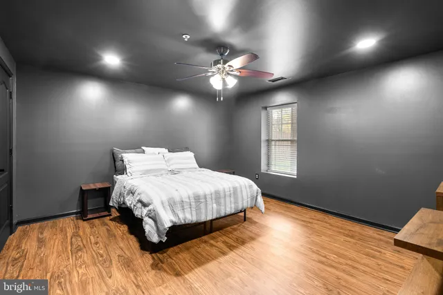 a bedroom with a large bed and a window