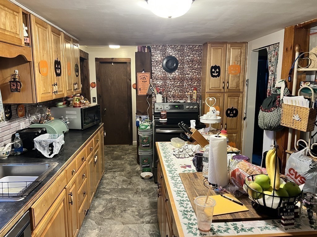 25 Main Road Phillipston, MA 01331 - Photo 15 of 42 a kitchen with stainless steel appliances kitchen island granite countertop a refrigerator and stove