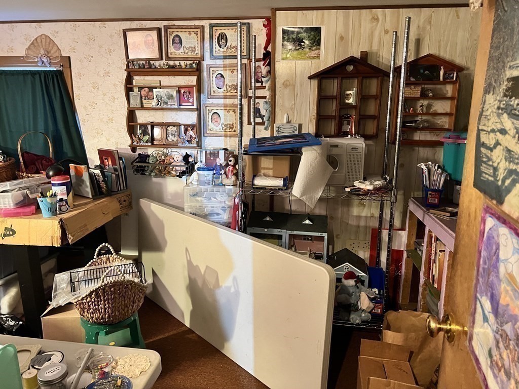 25 Main Road Phillipston, MA 01331 - Photo 30 of 42 a living room with furniture a flat screen tv and bookshelf