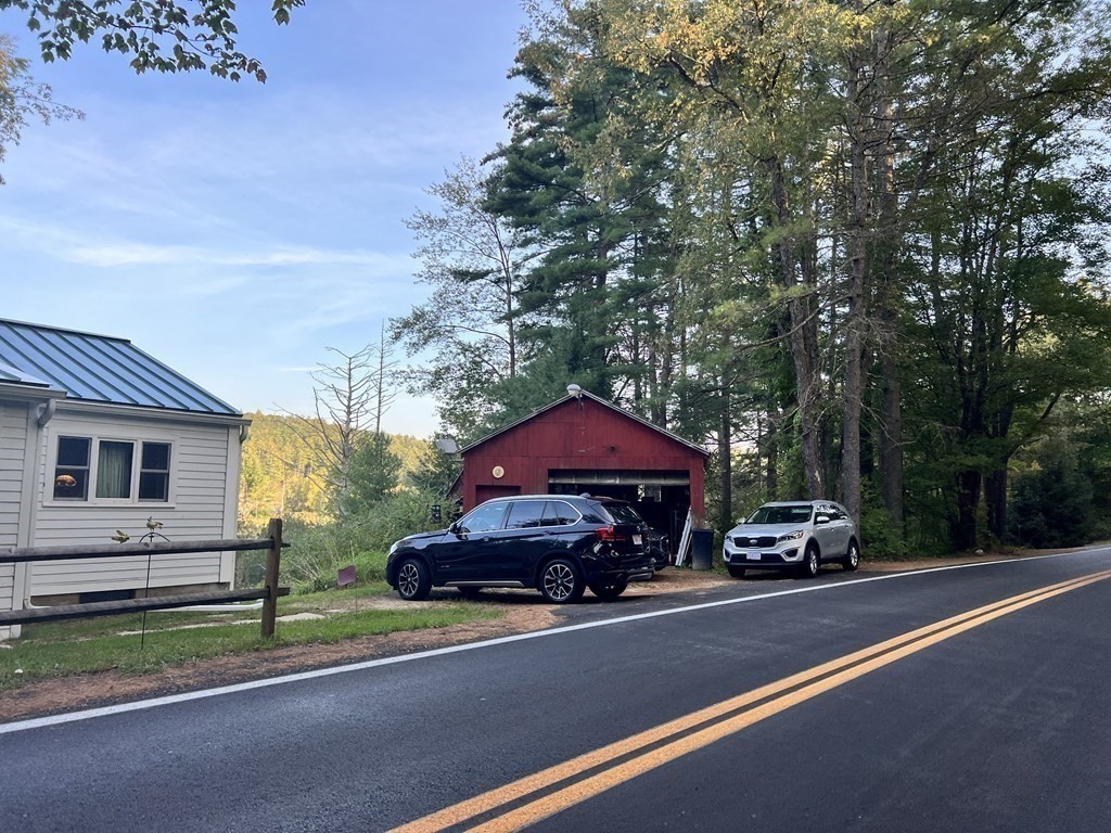 25 Main Road Phillipston, MA 01331 - Photo 5 of 42 a red car parked in front of a house