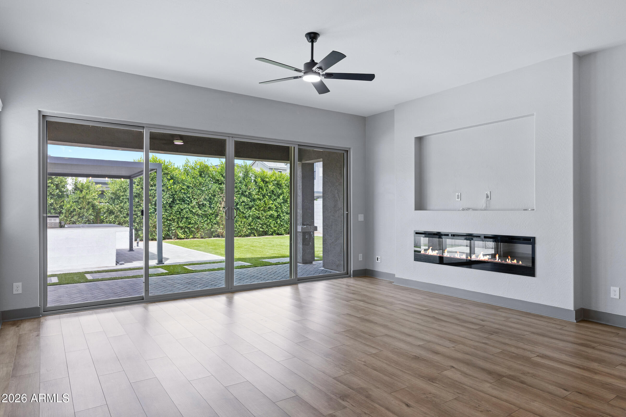 3900 East Appaloosa Road Gilbert, AZ 85296 - Photo 16 of 38 a view of an empty room with wooden floor and a window