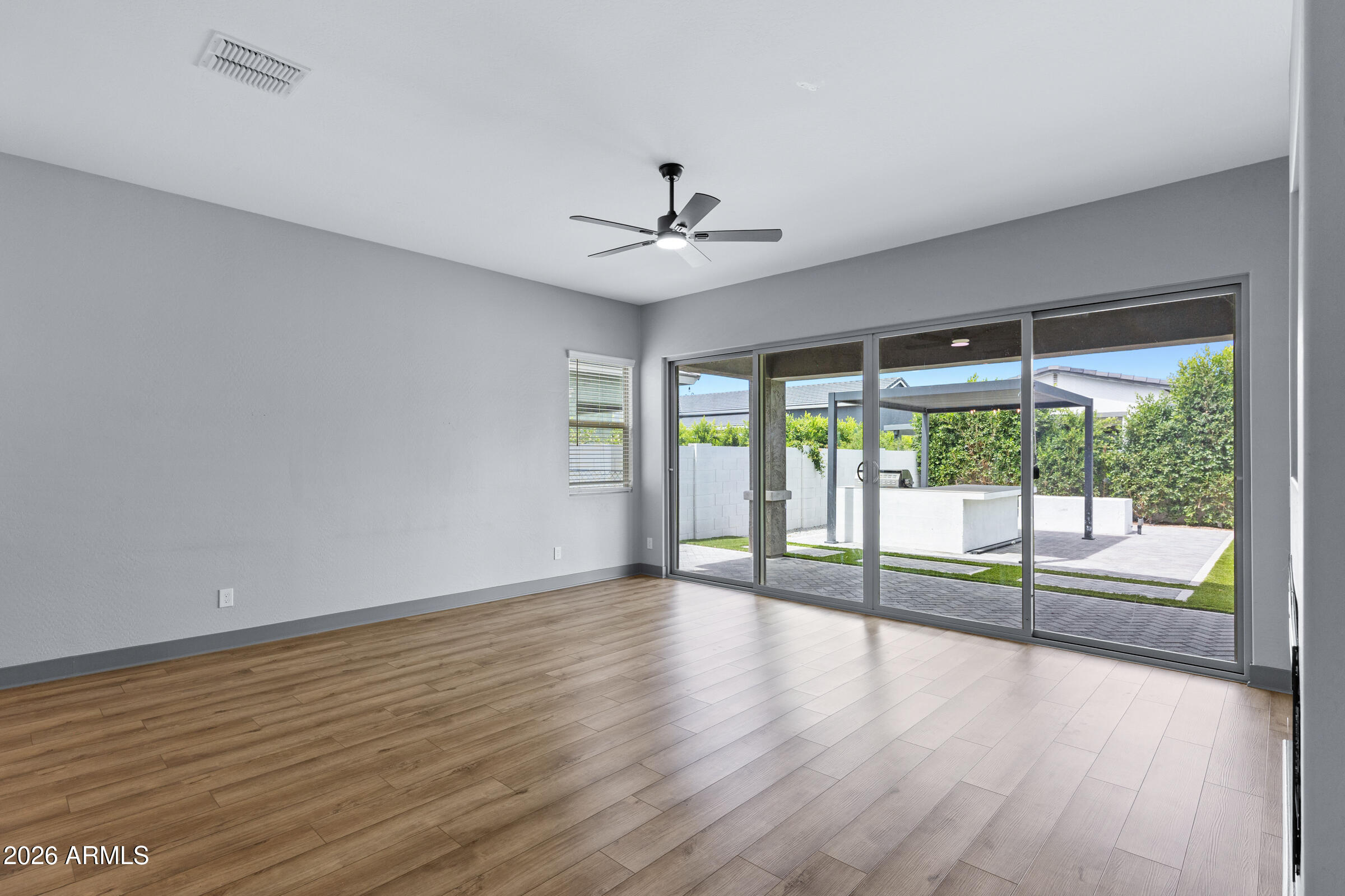 3900 East Appaloosa Road Gilbert, AZ 85296 - Photo 17 of 38 wooden floor in an empty room with a window