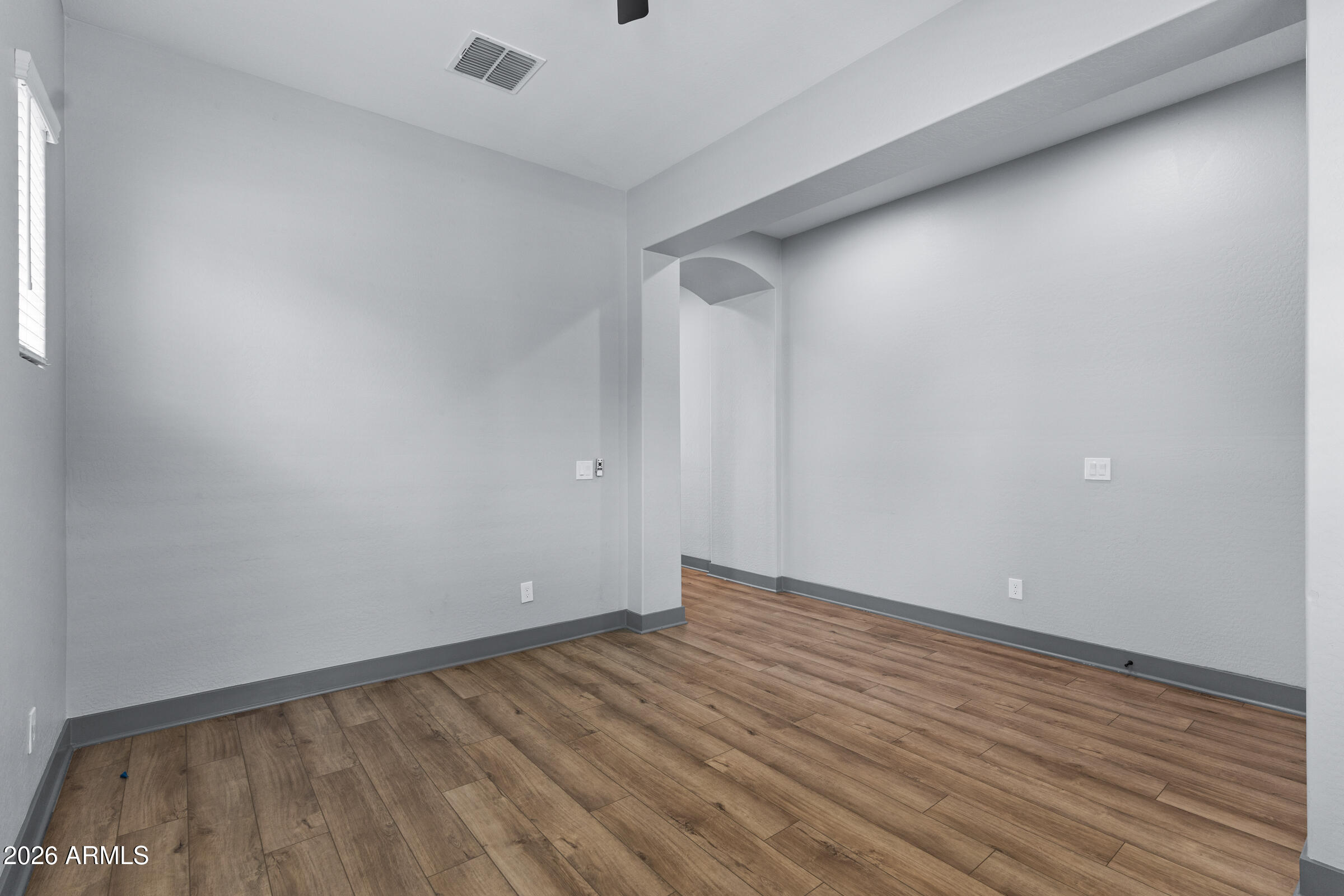 3900 East Appaloosa Road Gilbert, AZ 85296 - Photo 19 of 38 a view of an empty room with wooden floor