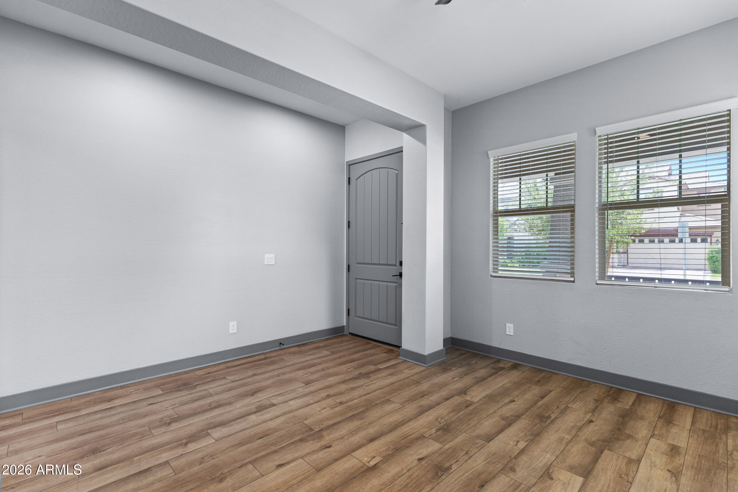 3900 East Appaloosa Road Gilbert, AZ 85296 - Photo 20 of 38 a view of an empty room with wooden floor and a window