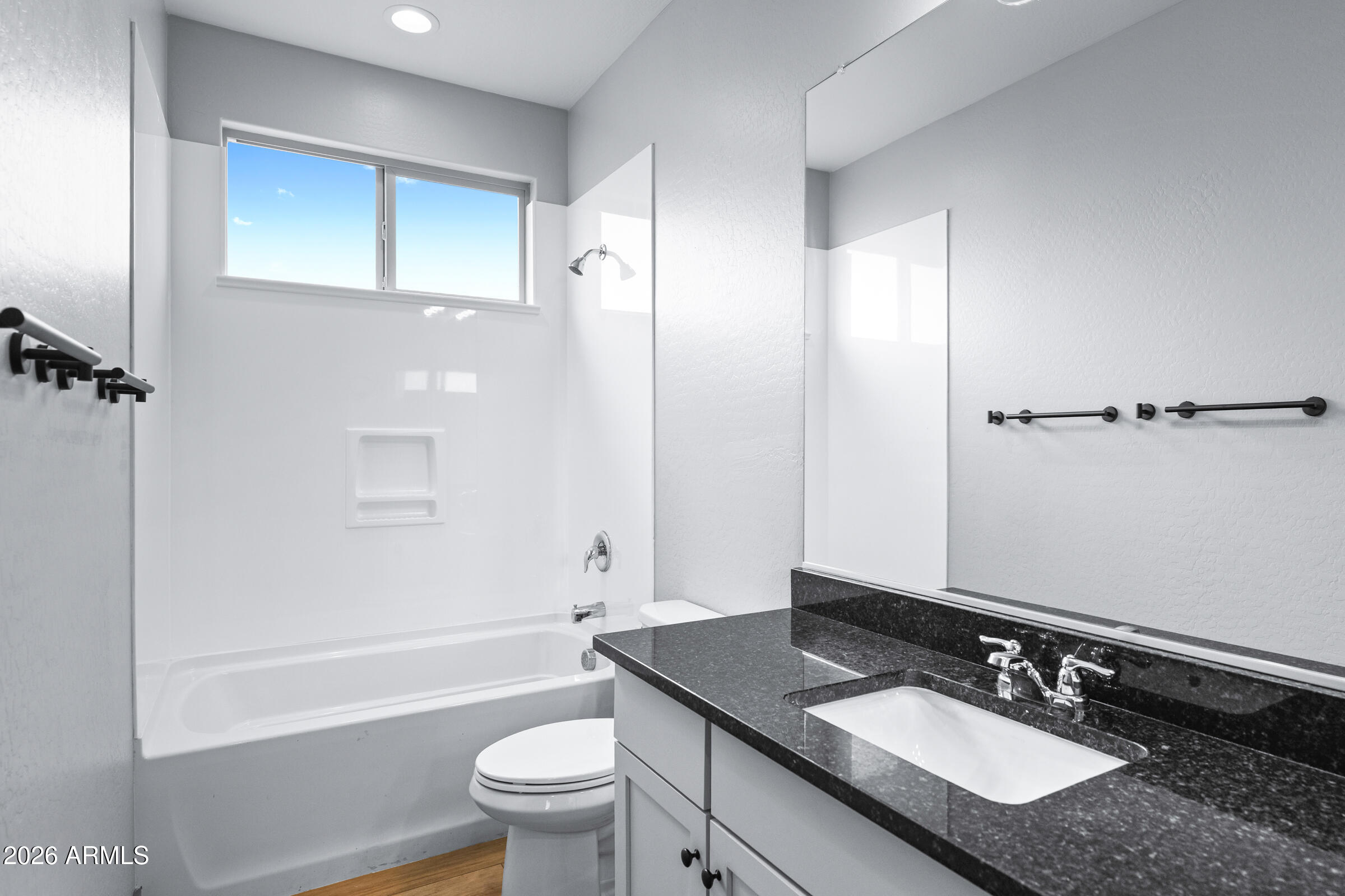 3900 East Appaloosa Road Gilbert, AZ 85296 - Photo 31 of 38 a bathroom with a granite countertop sink toilet and shower