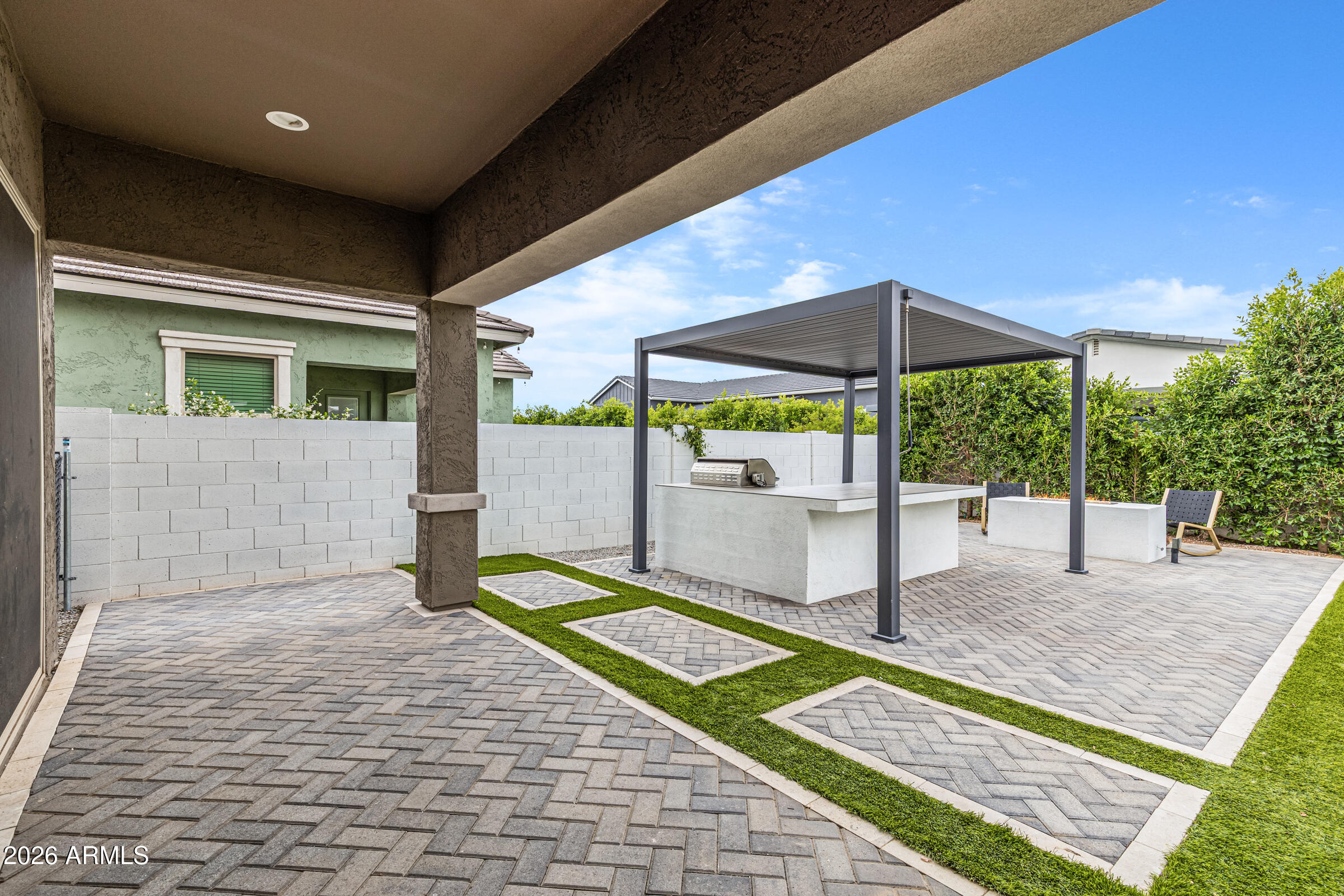 3900 East Appaloosa Road Gilbert, AZ 85296 - Photo 37 of 38 a patio with a table and chairs under an umbrella