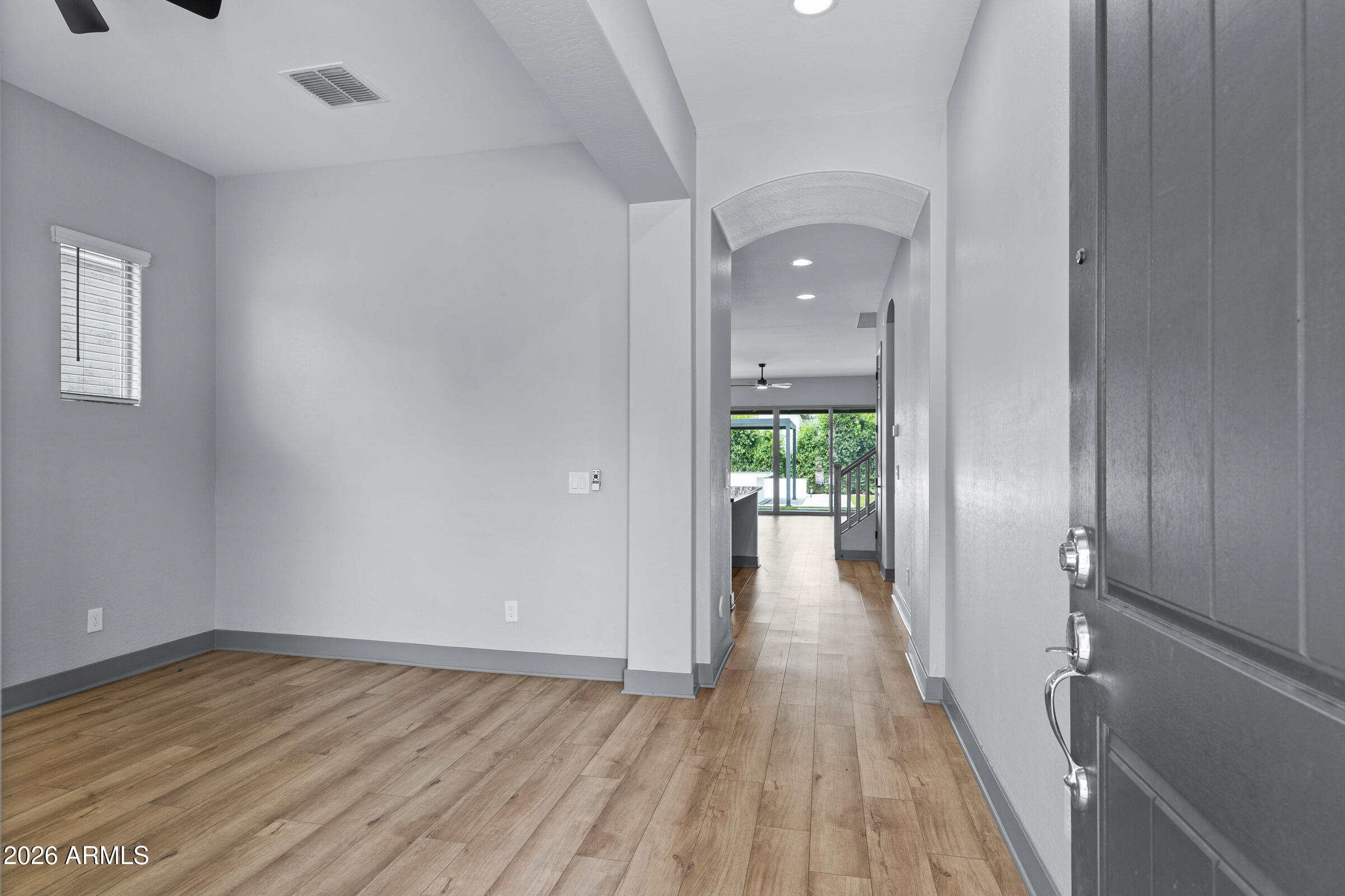 3900 East Appaloosa Road Gilbert, AZ 85296 - Photo 5 of 38 a view of a hallway view with wooden floor and staircase