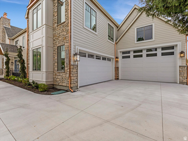 13216 Telemark Lane Draper, UT 84020 - Photo 38 of 41 Traditional-style house with stone siding, driveway, and an attached garage