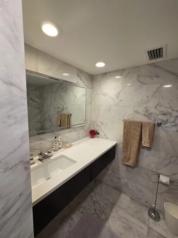 a bedroom with two beds and a painting on the wall