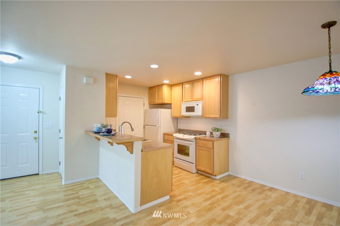 885 Cook Road, Unit 6 Sedro-Woolley, WA 98284 - Photo 12 of 31 a view of a kitchen with a stove wooden cabinets and a refrigerator
