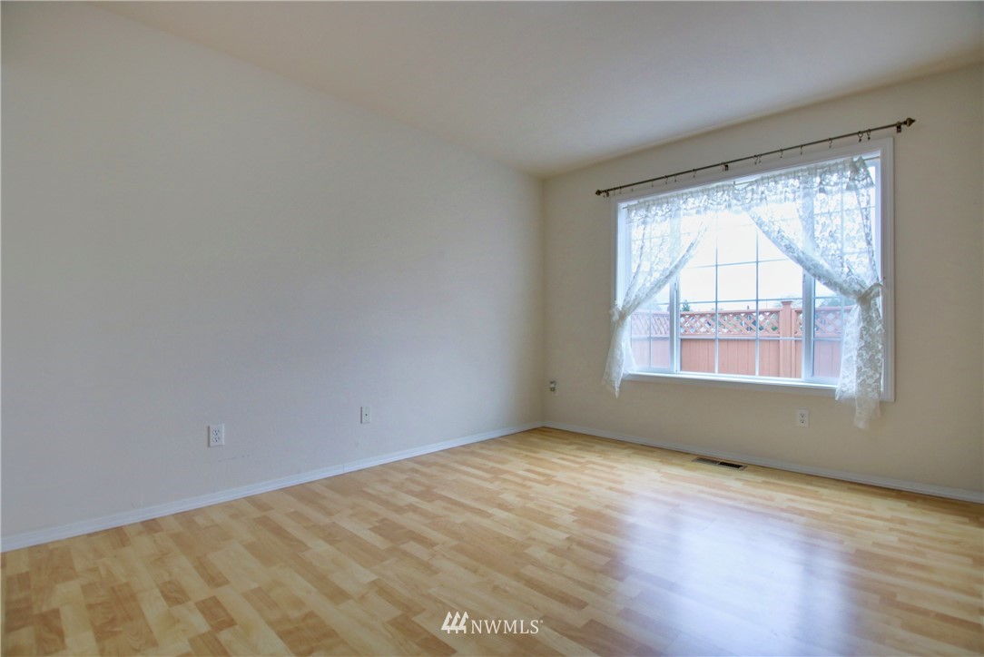 885 Cook Road, Unit 6 Sedro-Woolley, WA 98284 - Photo 17 of 31 a view of an empty room with wooden floor and a window