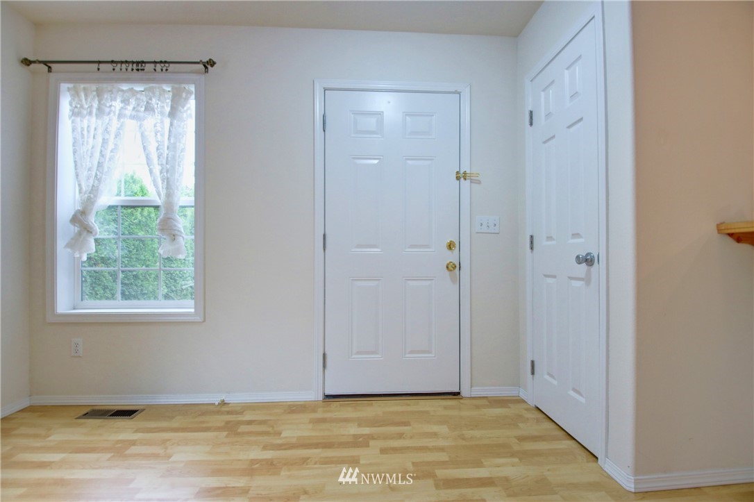 885 Cook Road, Unit 6 Sedro-Woolley, WA 98284 - Photo 5 of 31 a view of an empty room with wooden floor and a window