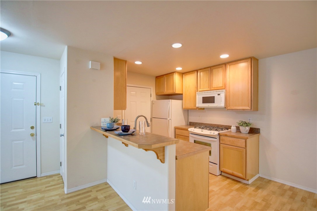 885 Cook Road, Unit 6 Sedro-Woolley, WA 98284 - Photo 7 of 31 a kitchen with a sink stove and refrigerator