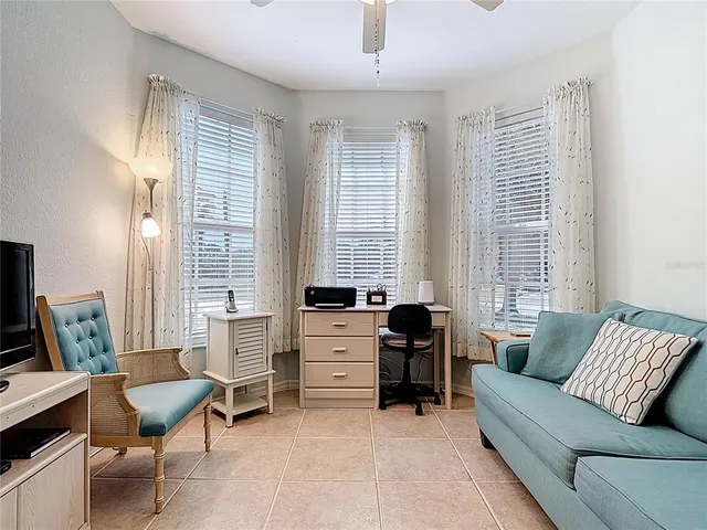 a living room with furniture and kitchen view
