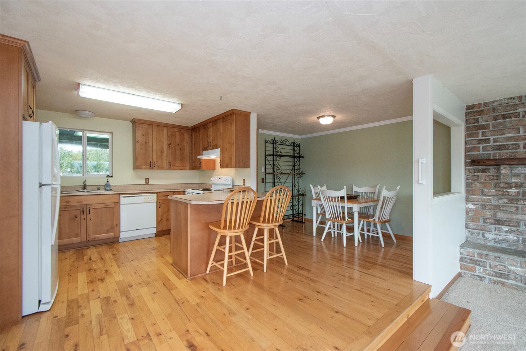 62 Hogback Road Sequim, WA 98382 - Photo 11 of 40 a dining room with stainless steel appliances a dining table chairs and view of kitchen