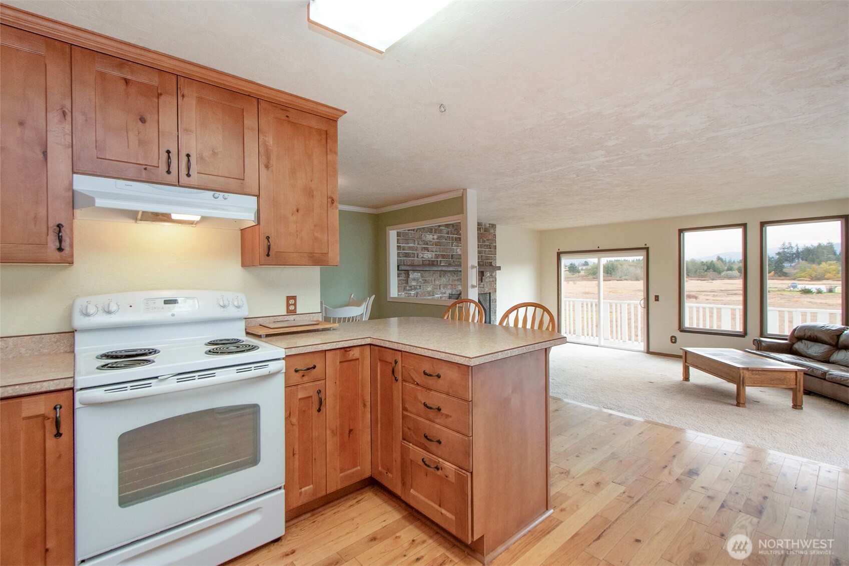 62 Hogback Road Sequim, WA 98382 - Photo 12 of 40 a kitchen with a stove a sink and a refrigerator