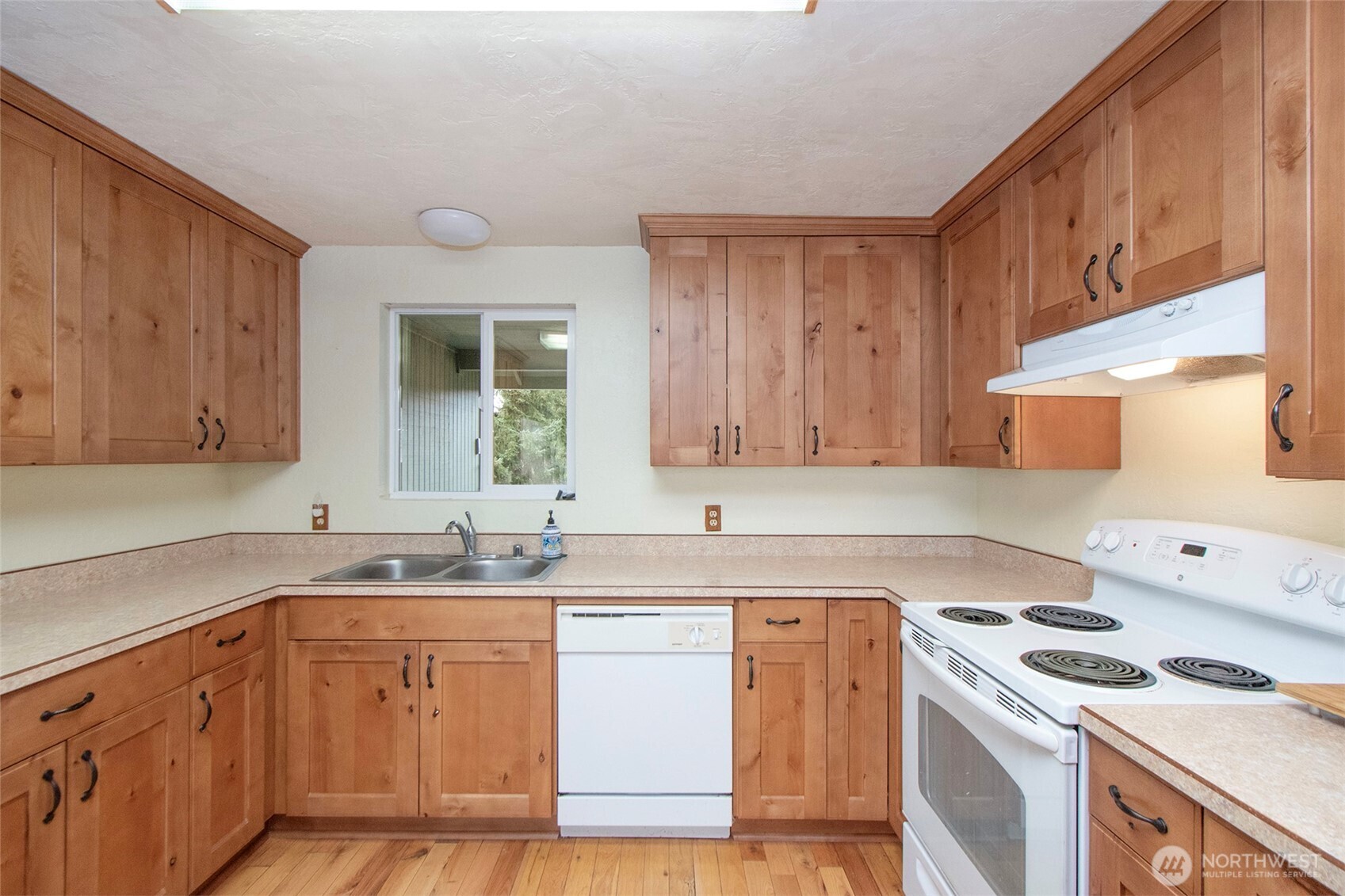 62 Hogback Road Sequim, WA 98382 - Photo 13 of 40 a kitchen with a sink a stove and cabinets