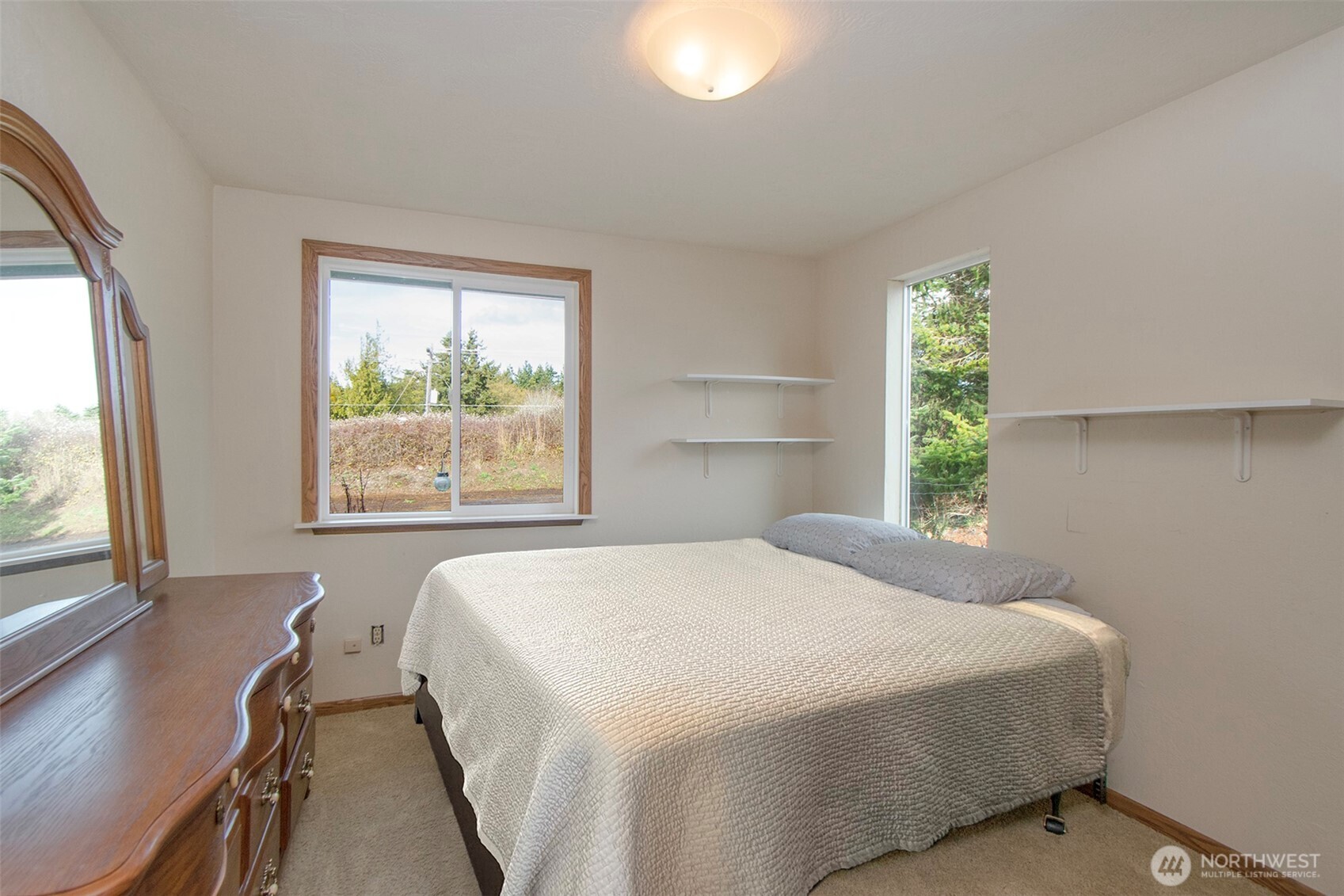 62 Hogback Road Sequim, WA 98382 - Photo 20 of 40 a bedroom with a bed and a large window