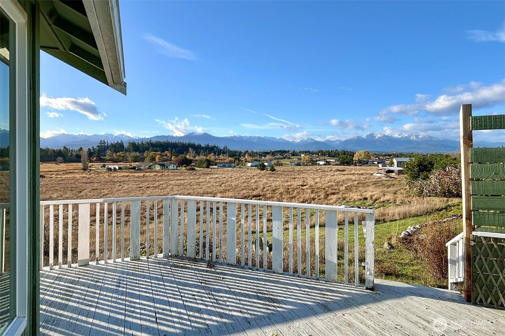 62 Hogback Road Sequim, WA 98382 - Photo 6 of 40 a view of a balcony with wooden floor and a lake view