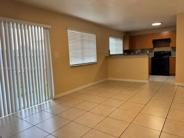 a view of a kitchen with an empty space and a window