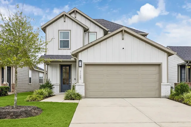 a view of backyard of house and garage