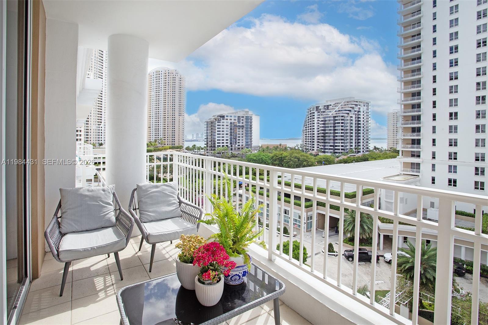 801 Brickell Key Boulevard, Unit 907 Miami, FL 33131 - Photo 19 of 53 a view of a balcony with chairs